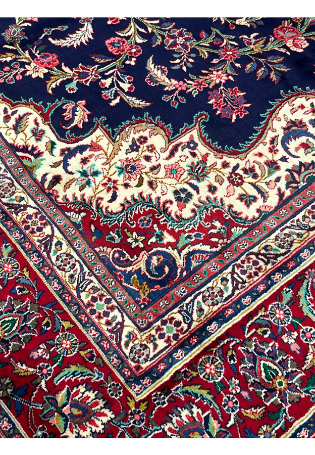 Inner border transition of Persian Qum kork rug, ivory minor border of vine and small flower heads framing the crimson main border
