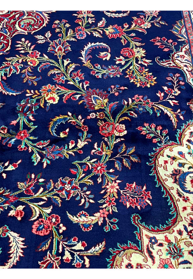Authentic 280 KPSI Persian Qum kork rug photographed flat, midnight navy ground, ivory spandrels, layered medallion at center