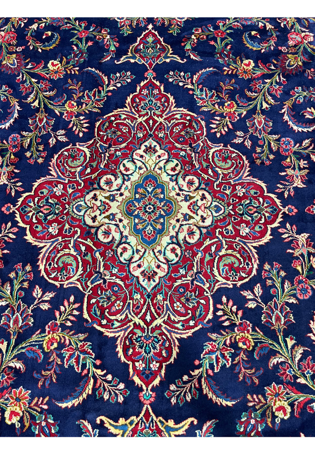 Closeup of inner medallion on Persian Qum kork wool rug, fine kork wool drawing visible at the teal blue and ivory core