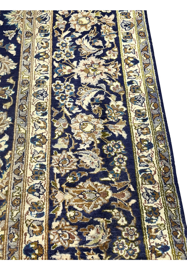 Border close-up of Persian Kashan, navy main border with ivory palmettes and camel leaves, ivory guard stripes, handmade