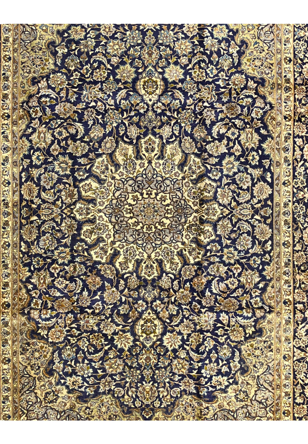 Midfield view of Persian Kashan rug, navy ground with continuous arabesque, ivory and camel palmettes, fine workshop drawing