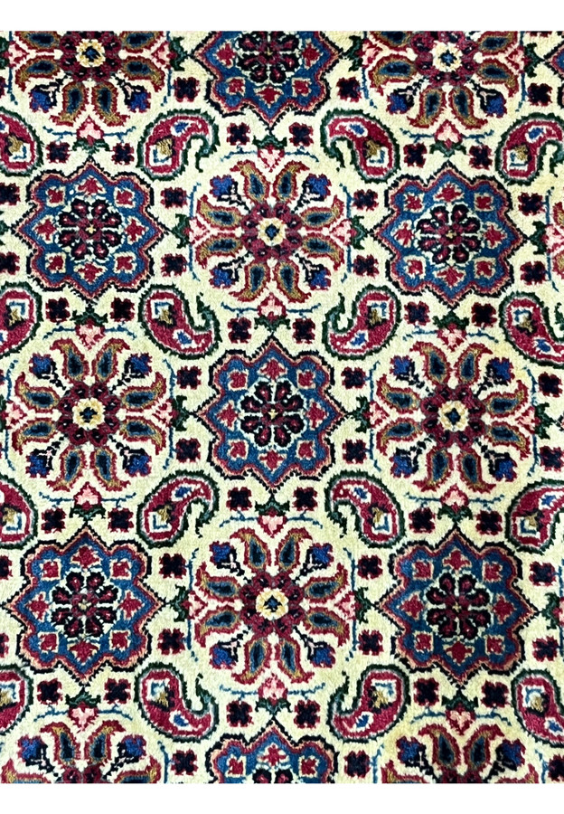 Pattern close-up of Persian Mashad, eight-point rosettes and curling paisleys in diamond cells, fine workshop weaving