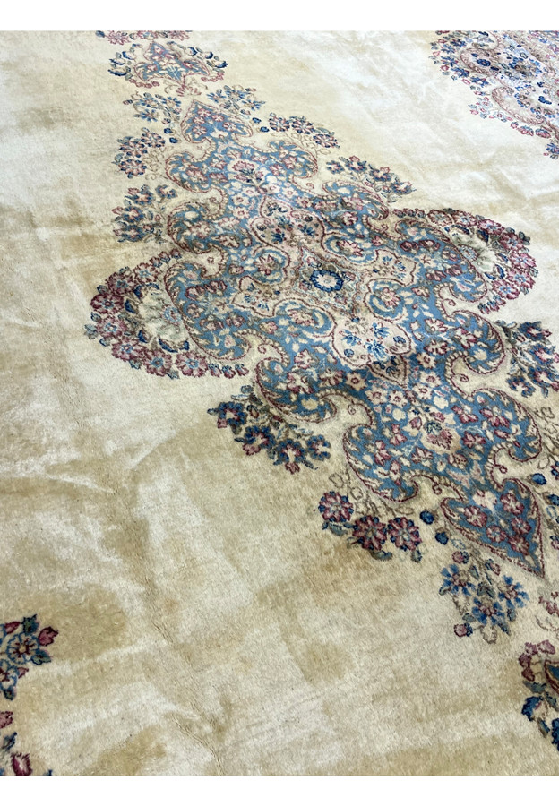 Medallion and ivory field close-up of fine Persian Kerman, sky blue cartouche with sage green and rose floral detail