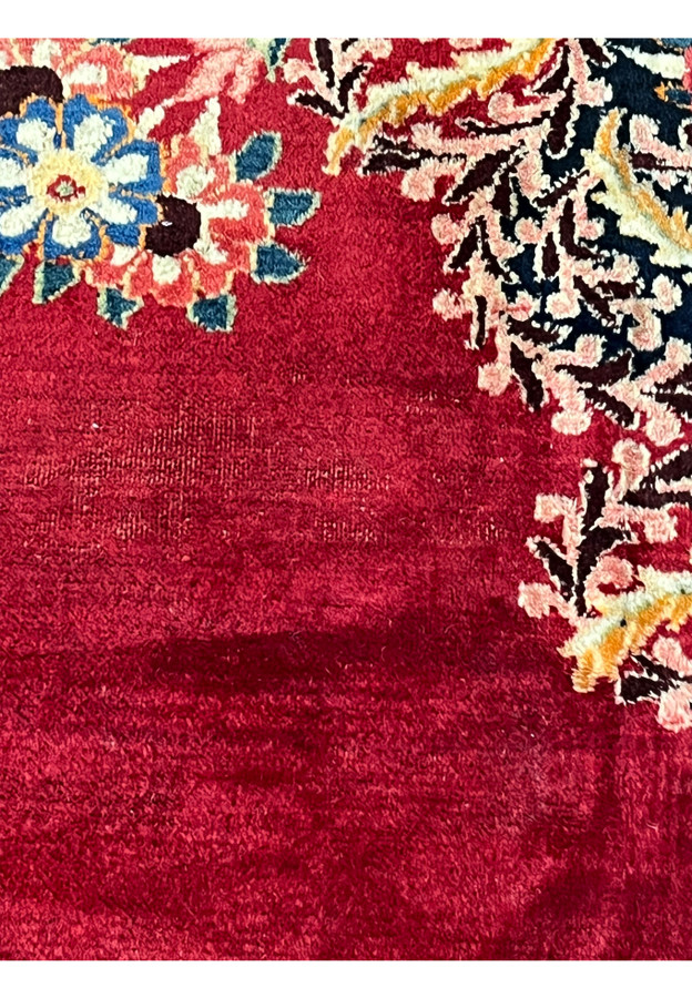 Field of antique Persian Moud showing natural abrash, soft horizontal tonal banding in deep red ground, hallmark of hand dyed wool