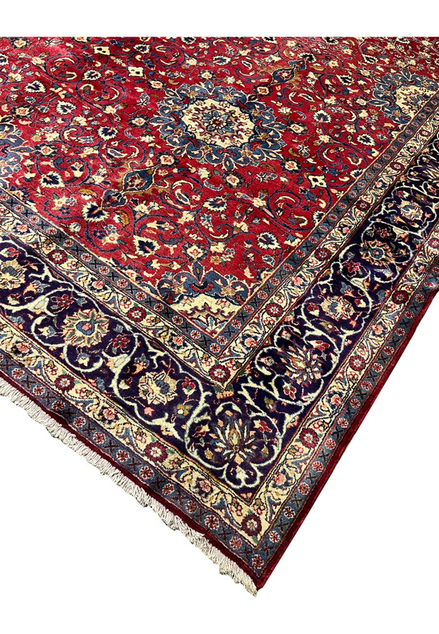 Corner edge of 9x13 Persian Isfahan rug, intact selvedge and crisp navy guard borders, never used handmade wool rug