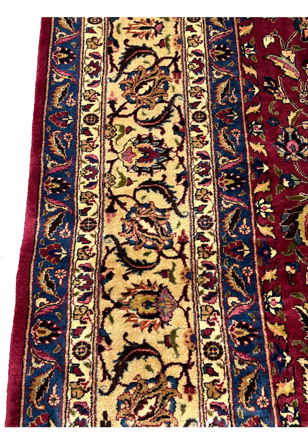 Border closeup Persian Mashad rug, palmette and saz leaf motifs in red and navy on gold ground, fine wool on cotton handmade in Persia