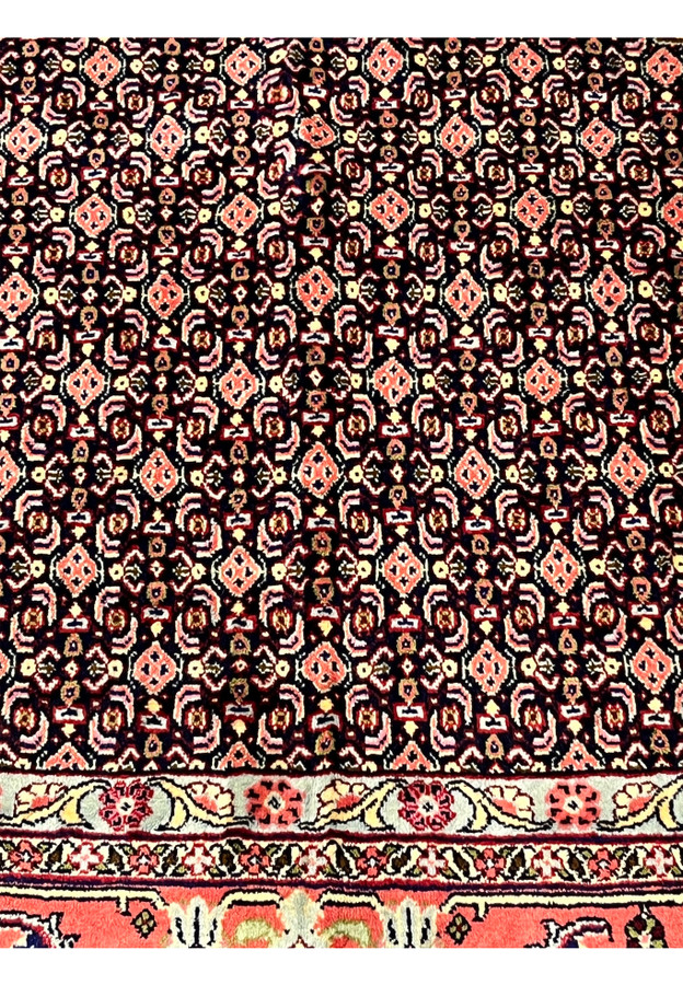 Color closeup Persian Senneh rug, herati cells in red ivory and navy on pale blue ground, fine wool on cotton handmade