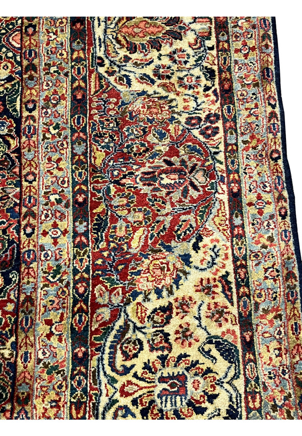 Ivory ground border close-up on antique Sarough, classic turtle palmette and rosette procession in rose and navy