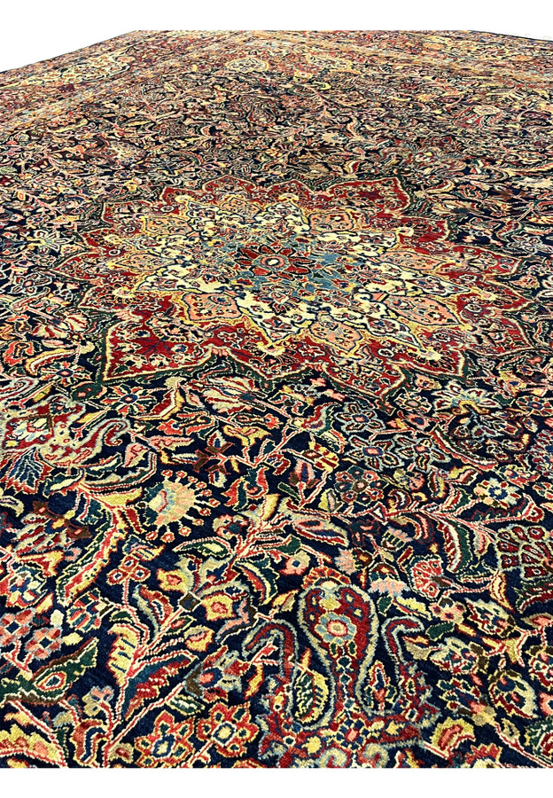 Field close-up of authentic handmade Persian Sarough showing stepped medallion edge and surrounding palmette work