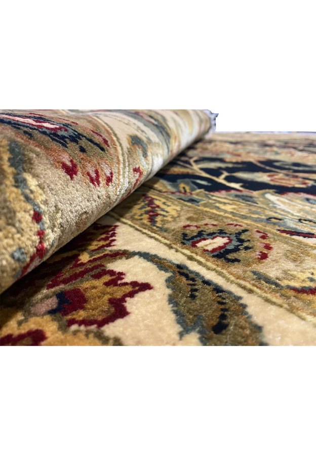 Pile depth view of oversize Jaipur rug, full wool pile with midnight blue field and antique gold border at the edge