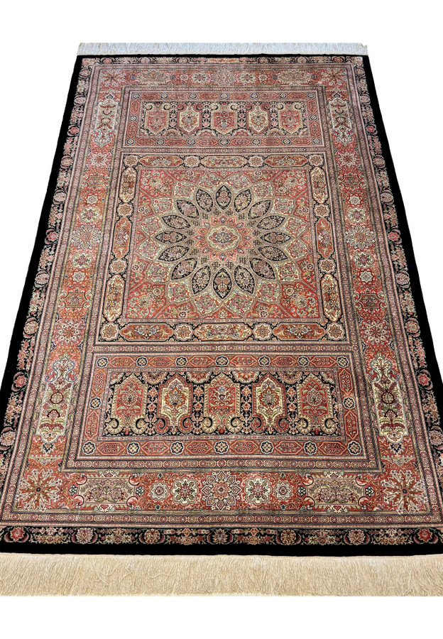 Master Hossein Kashizadeh signed Persian Qum silk rug laid down, black field with terracotta and ivory dome medallion