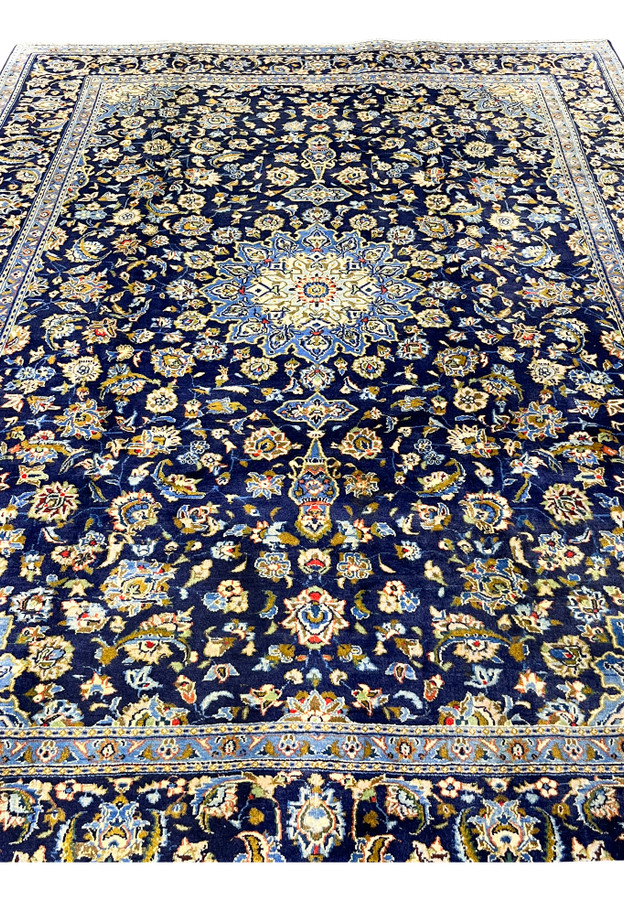 Navy Persian Kashan rug midfield showing dense Shah Abbas palmettes around the central star medallion