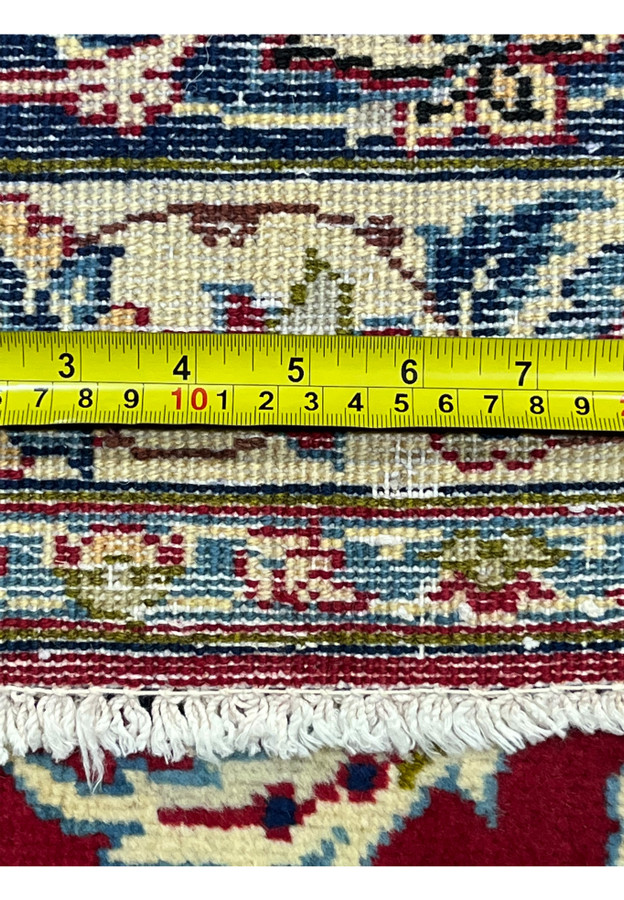 Backside knot detail with tape measure documenting the hand-knotted density of this wool Najafabad rug