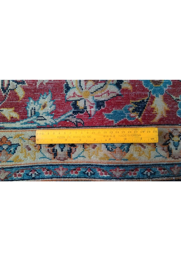 Backside of Persian Isfahan rug measured against a ruler, fine wool and silk on silk weave