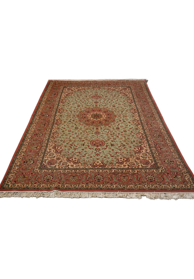 Persian Isfahan wool and silk rug laid down, soft green field with allover floral and rose medallion