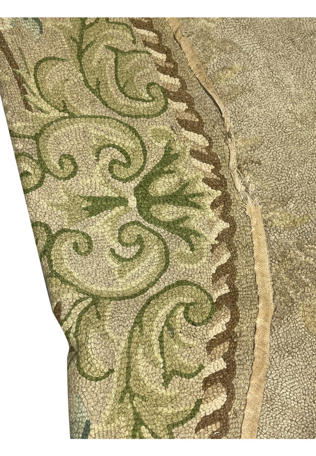 Reverse view showing cotton foundation, cloth edge binding and overall construction of antique oval hooked rug