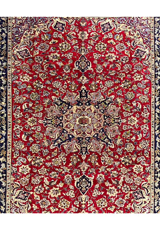 Mid-field detail of Persian Najafabad rug showing dense palmette and vine drawing on a deep red ground, fine wool weave