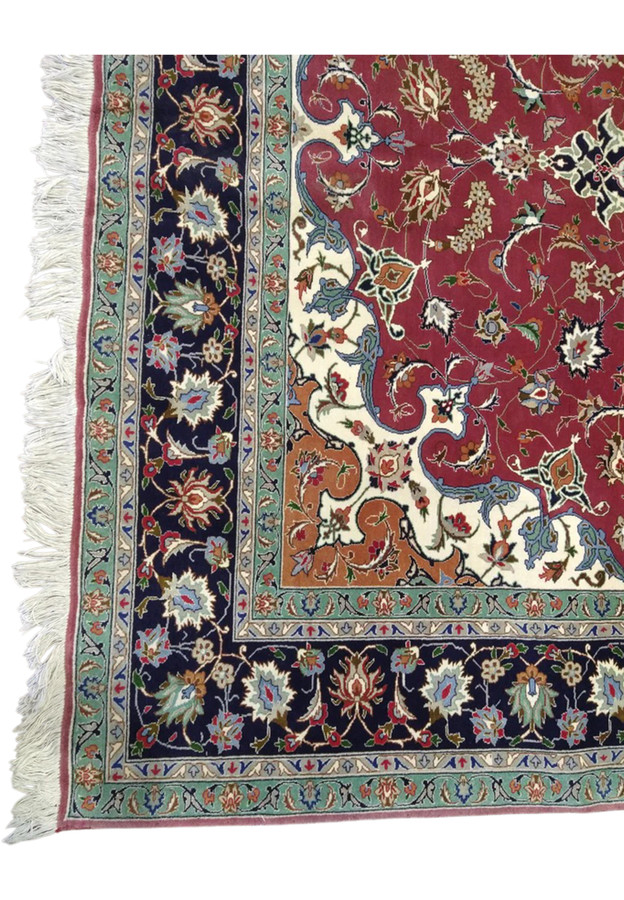 Corner border detail of Persian Tabriz 60 raj rug, navy main border palmettes flanked by mint secondary borders