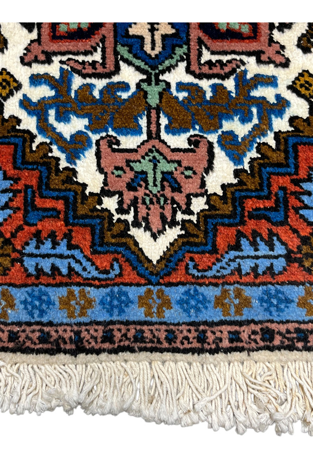Lower section of Persian Ardebil baby rug, ivory medallion edge with sky blue corner bracket on rust field