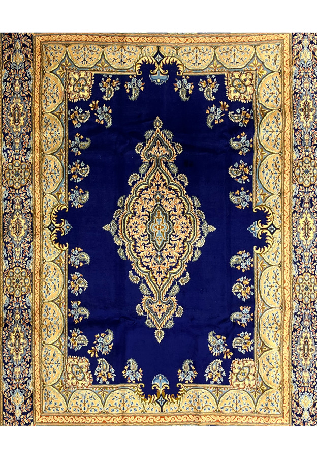 Tight closeup of central field of Persian Yazd rug, peach and gold floral medallion on midnight navy with scattered boteh