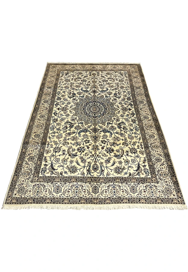 Full ivory Nain rug shown at an angle with blue medallion, vine scroll field and floral borders