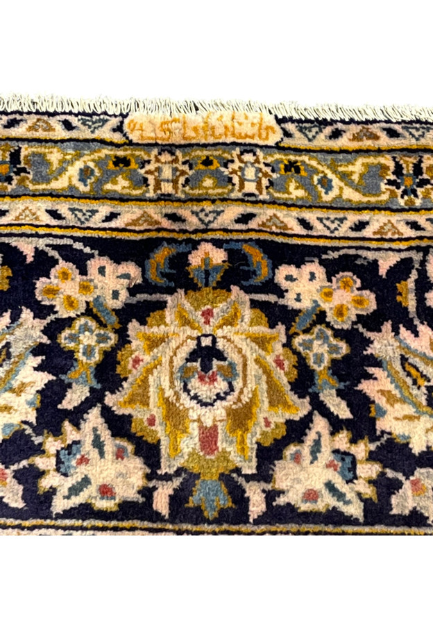 Woven Farsi workshop signature on the end border authenticating this signed Persian Kashan rug