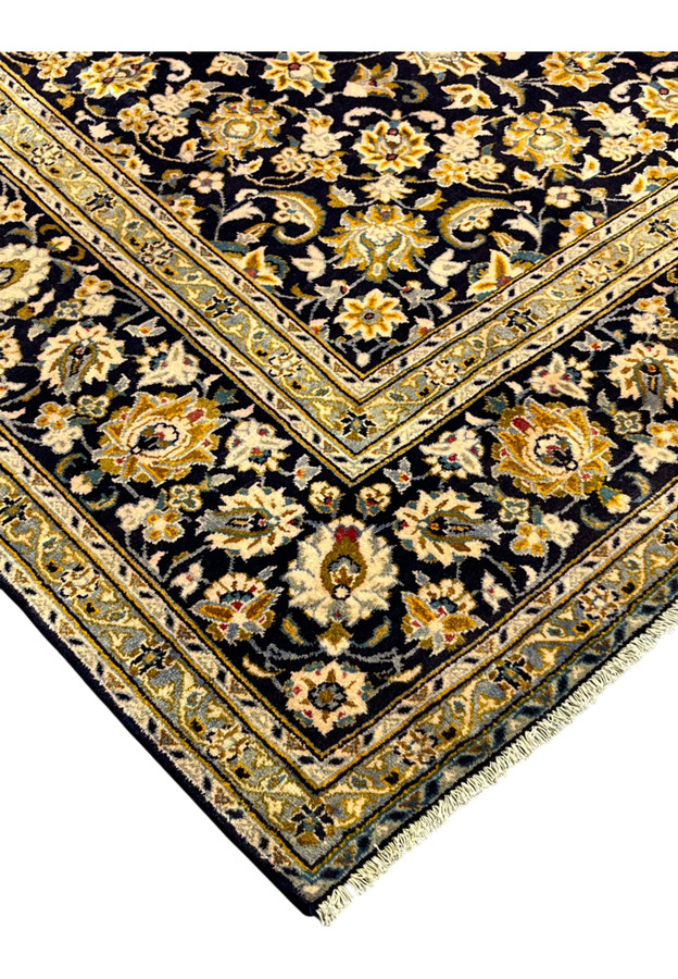 Corner detail of the Persian Kashan with celadon guard bands and navy palmette border