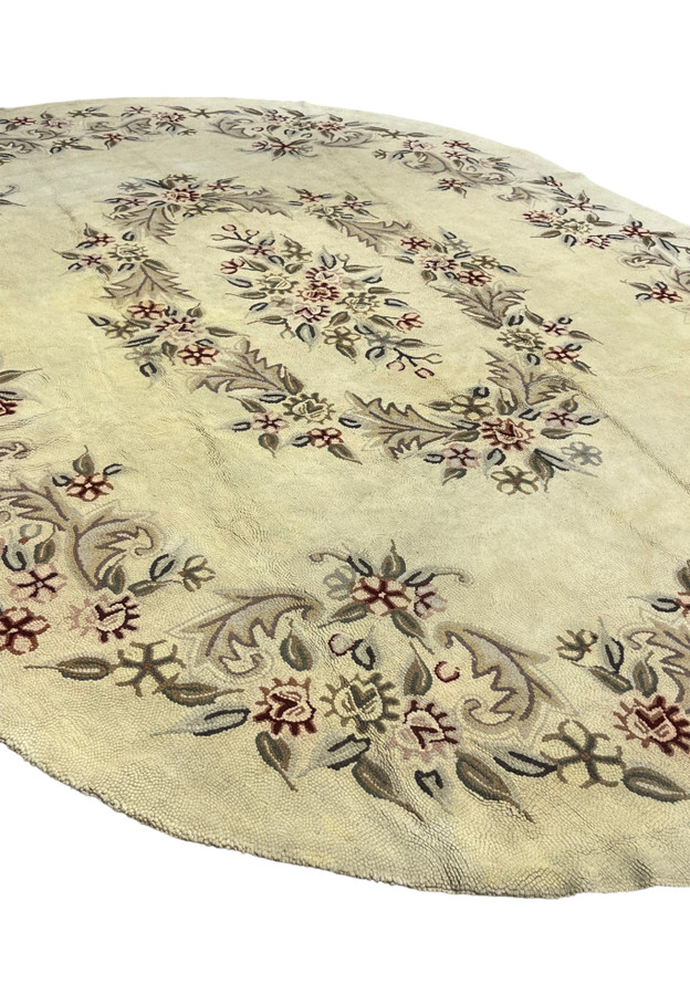 Full perspective of the large oval hooked rug with French style floral swags from India