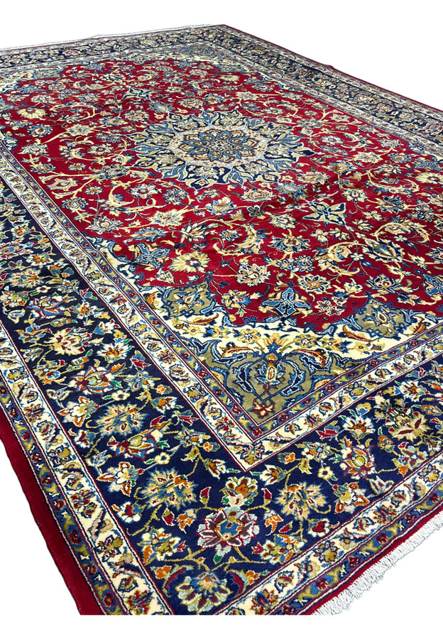 Angled view across the 10x14 Najafabad highlighting the wool pile and jewel tones