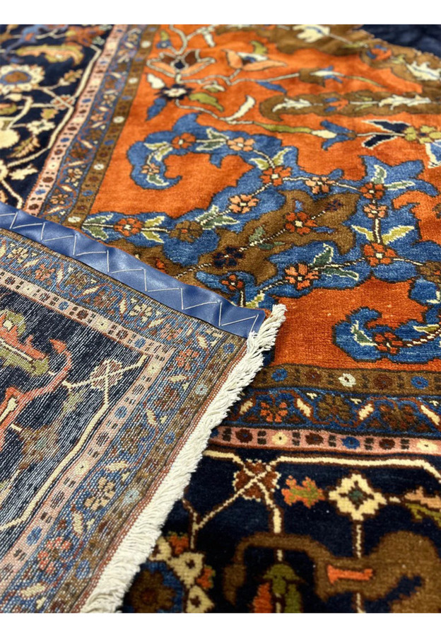 Reverse of the rust and navy Heriz showing the hand knotting and clear pattern