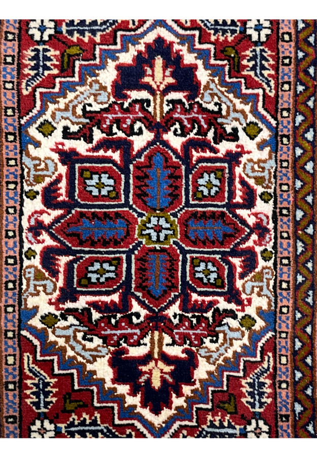 Geometric stepped medallion of the Ardebil in ivory navy and royal blue on red ground