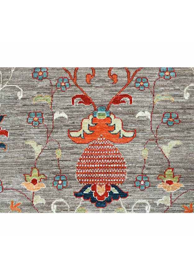 Detail of a rust pomegranate palmette with teal blossoms and navy leaves on the grey ground