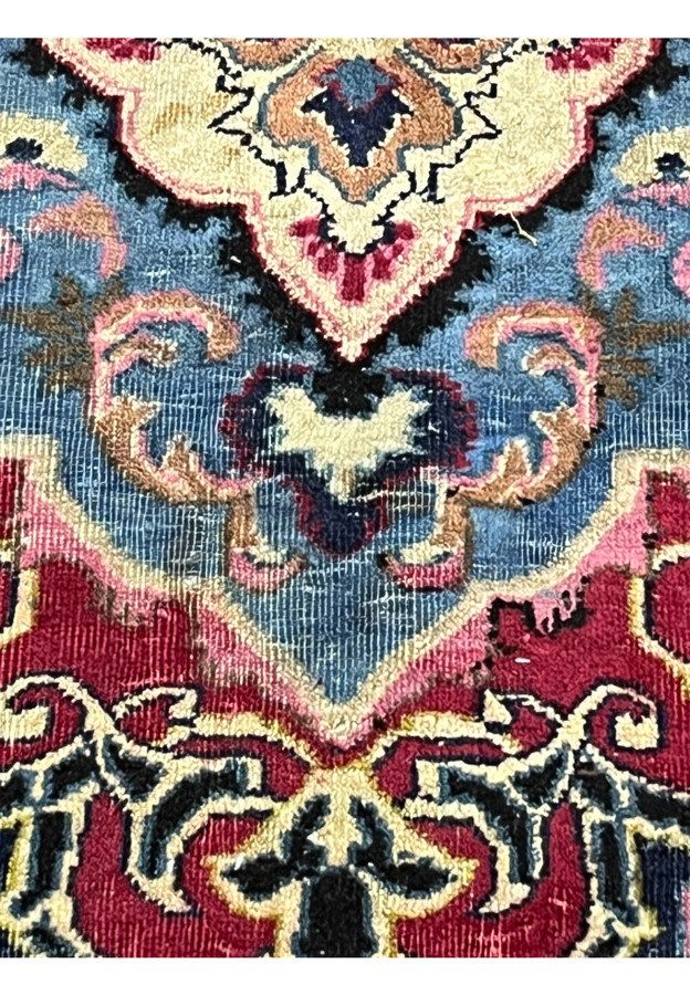 Pile detail of the Kashmar showing the soft blue medallion and aged wool surface