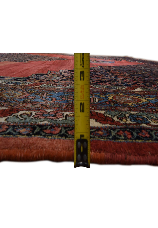Side view of the antique Bijar showing deep, dense pile measured against a tape, durable wool