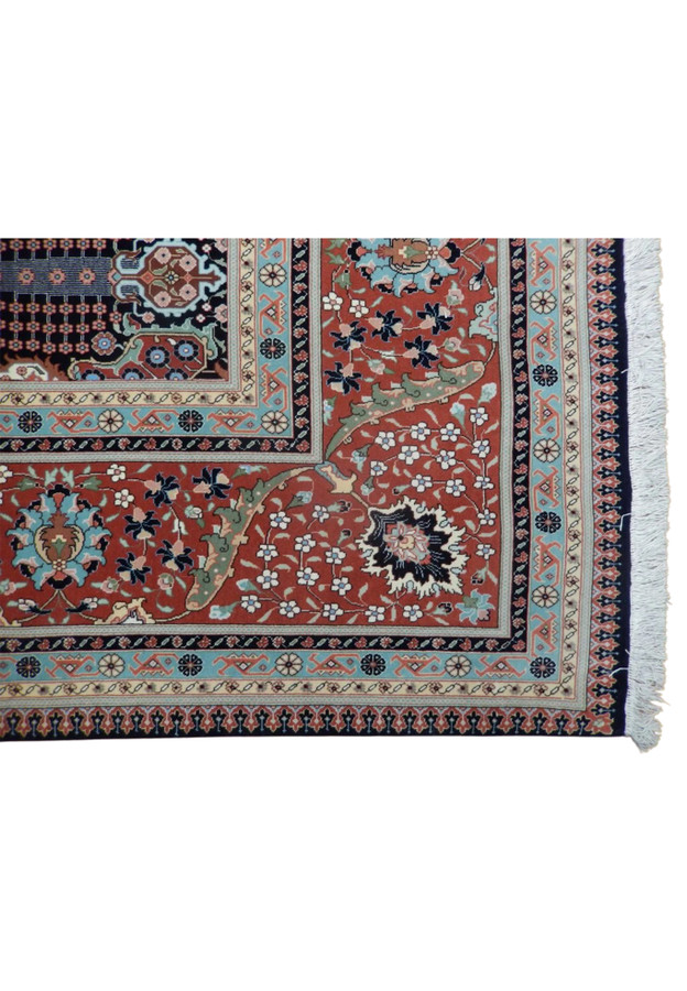 Brick-red turtle border with flowering vines and sky-blue guard stripes, authentic handmade Tabriz detail
