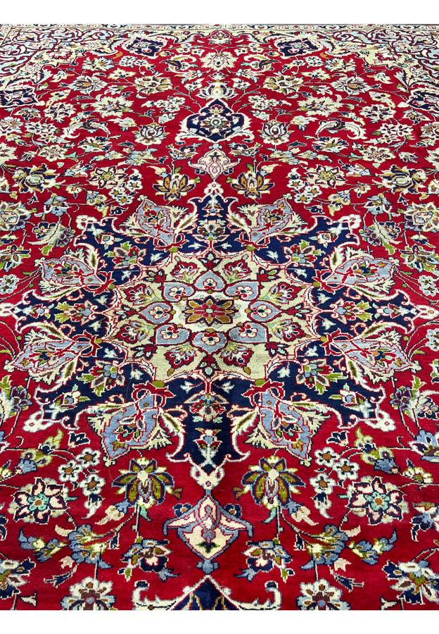 Central medallion in navy and cream surrounded by powder blue petals and red floral tracery.