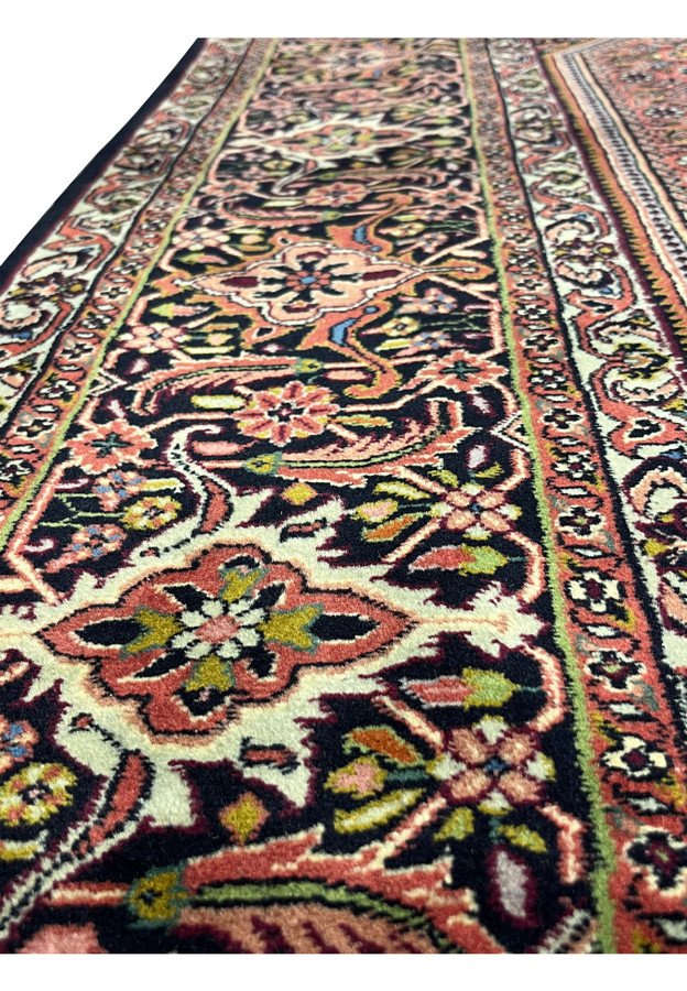 Border close-up with turtle palmettes and rose florals on a navy ground.