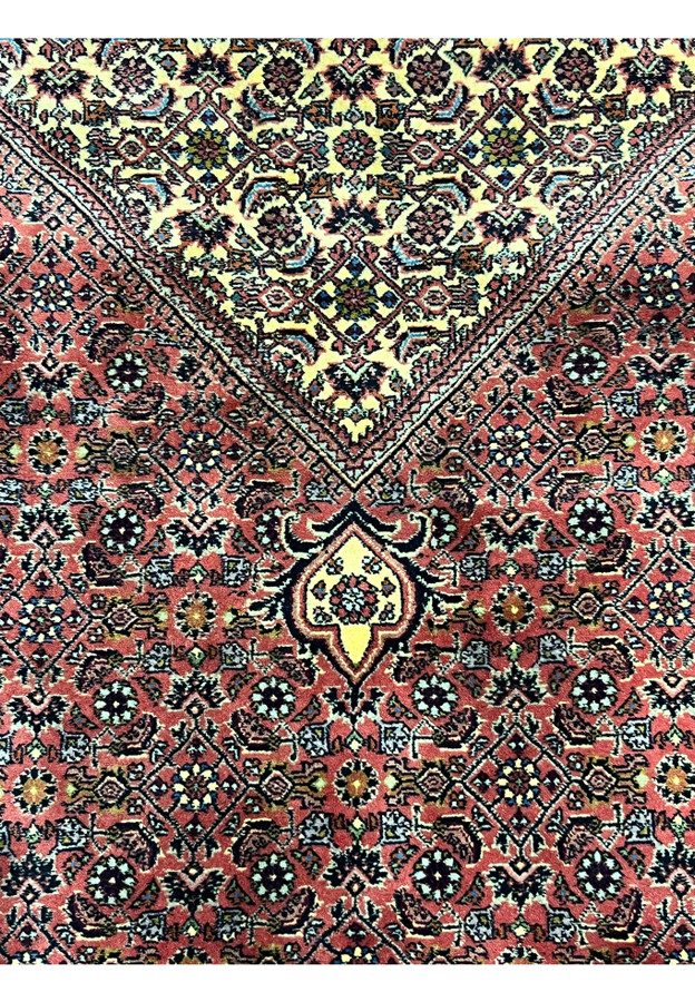 Close detail of the Herati mahi motifs, diamonds, rosettes, and curved leaves across the field.