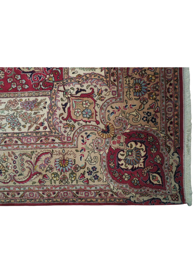 Ivory pictorial border with willows, flowering trees, and birds framing authentic Kerman craftsmanship
