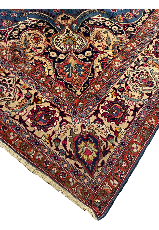Side edge and corner view showing border condition of vintage blue Mashad carpet