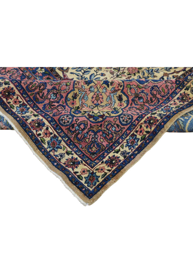 Folded edge detail showing border layers and gentle patina of antique hand knotted carpet