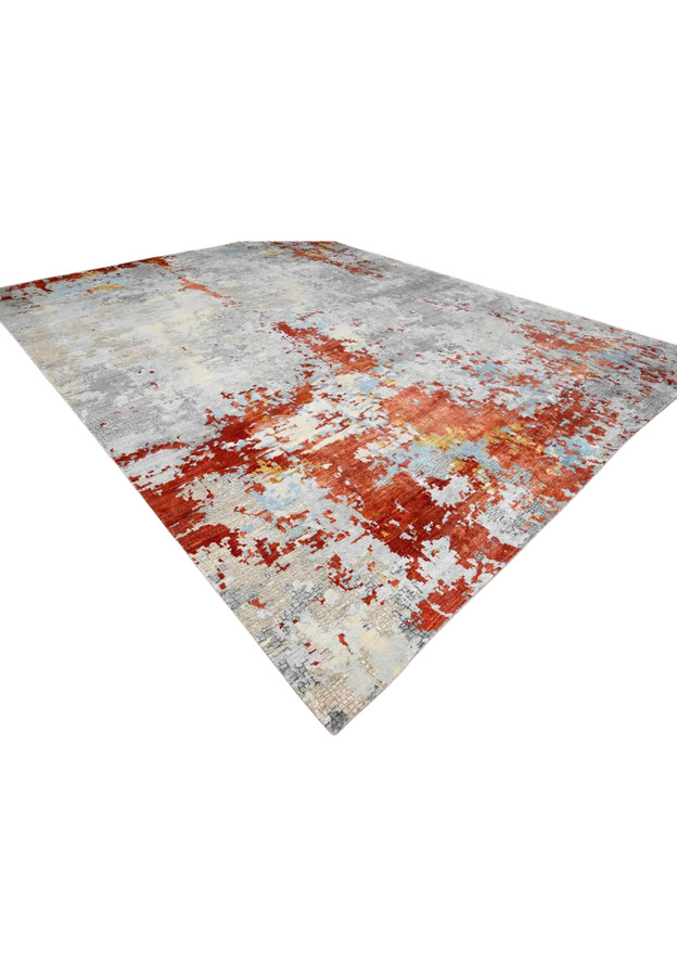 Angled view of 14x18 contemporary wool and silk rug with rust red and light blue abstract field