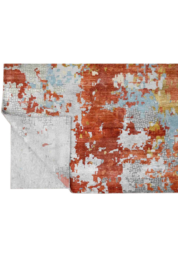 Folded corner revealing tight hand-knotted weave beneath the fire mosaic abstract pattern