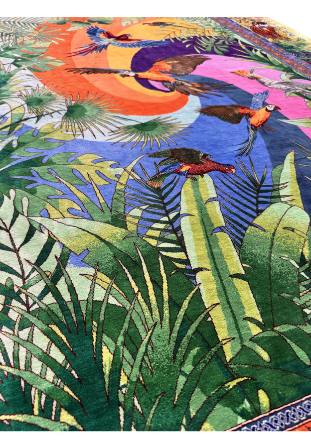 Blue and gold macaw in flight over a swirling purple and orange silk sunburst