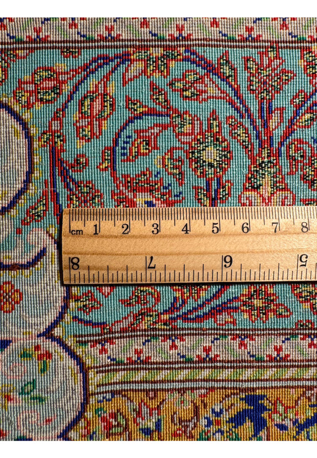 Ruler across silk foundation showing extreme knot density of the Qum weave