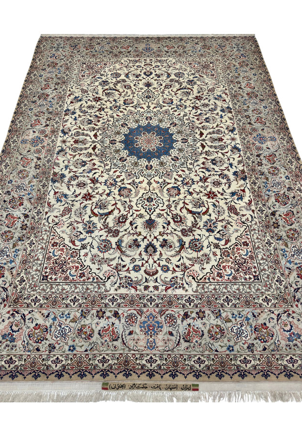 9x12 Persian Isfahan rug laid flat, ivory ground, camel outer border and blue central medallion