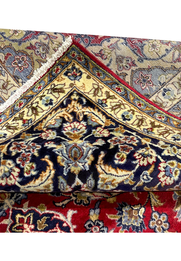 Folded corner revealing the woven back beside the navy and ivory border front