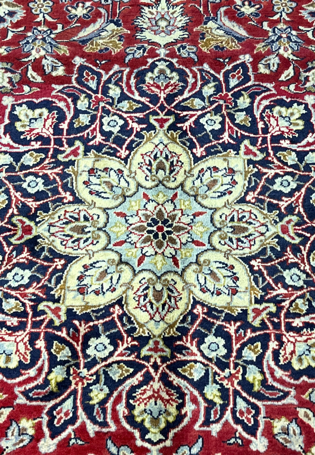 Medallion close up showing the 8 point rosette and hair thin red vinework around it
