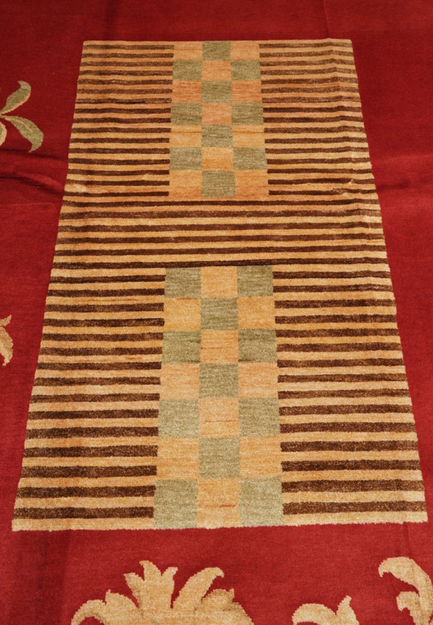 Striped panel with sage and apricot checkerboard squares set into the red field
