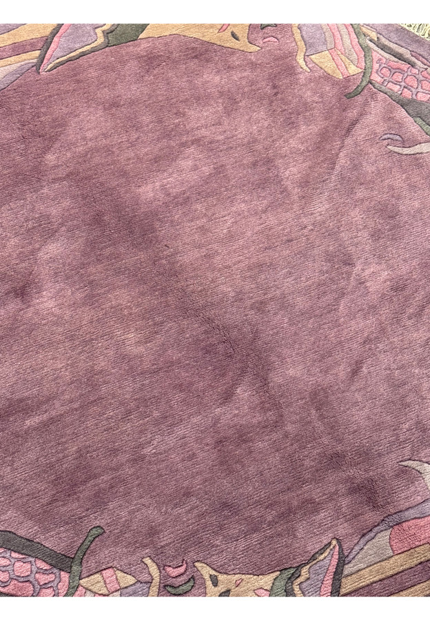 Close-up of the soft heather mauve field showing plush wool pile and gentle tonal abrash